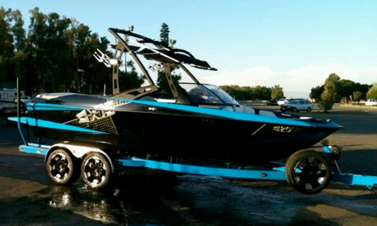 blue wakeboarding boat